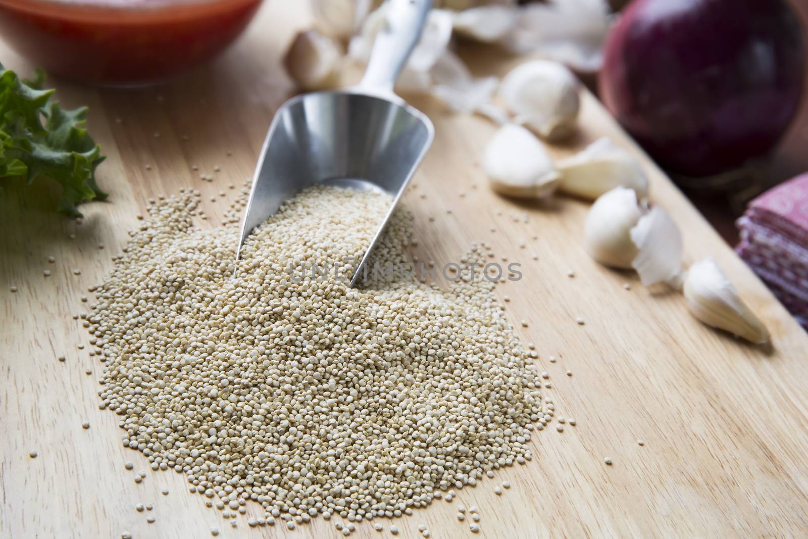 Scoop of quinoa surrounded by ingredients to make vegan Sloppy Joes.