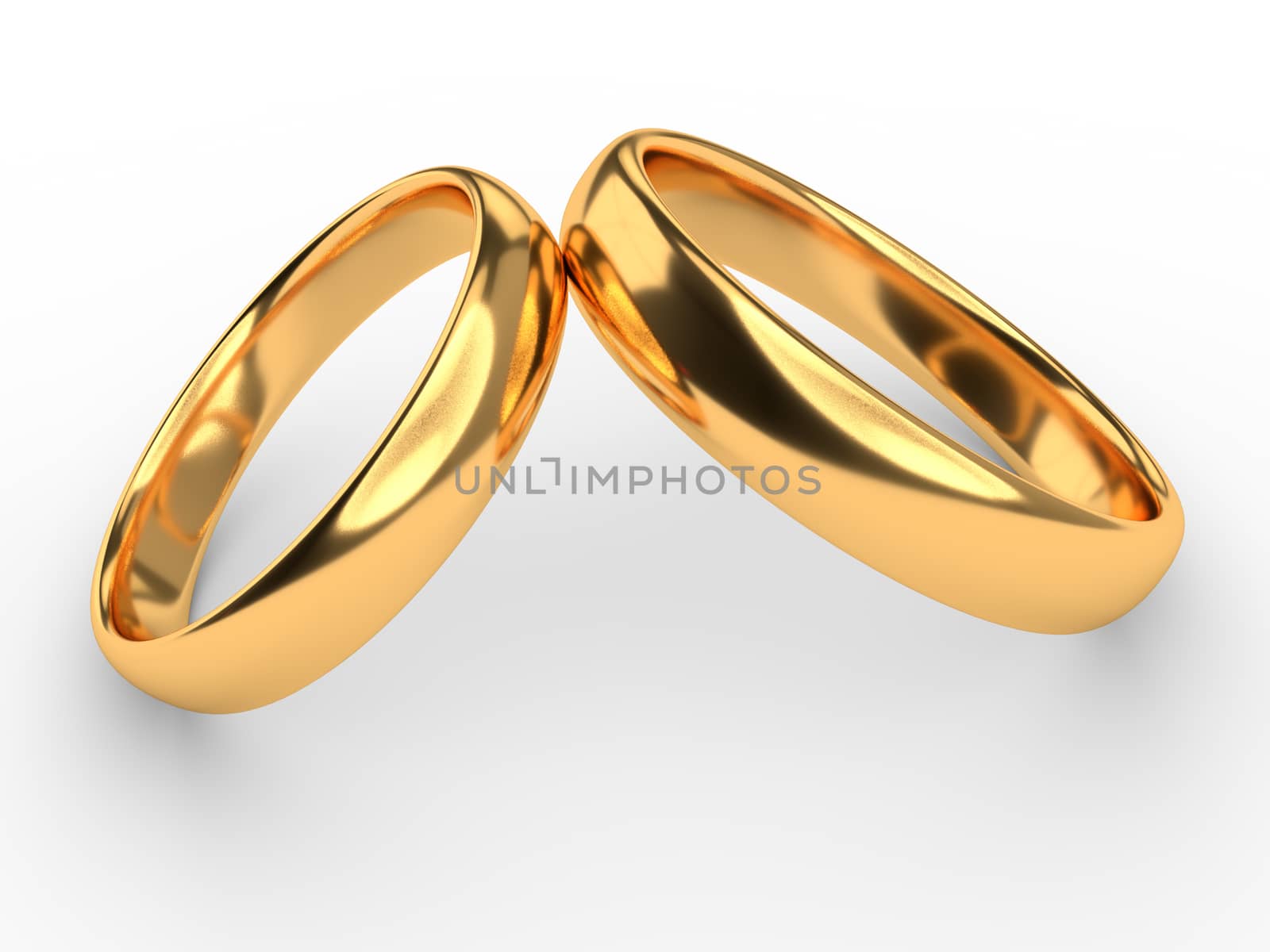 Two wedding gold rings lie on each other isolated on white