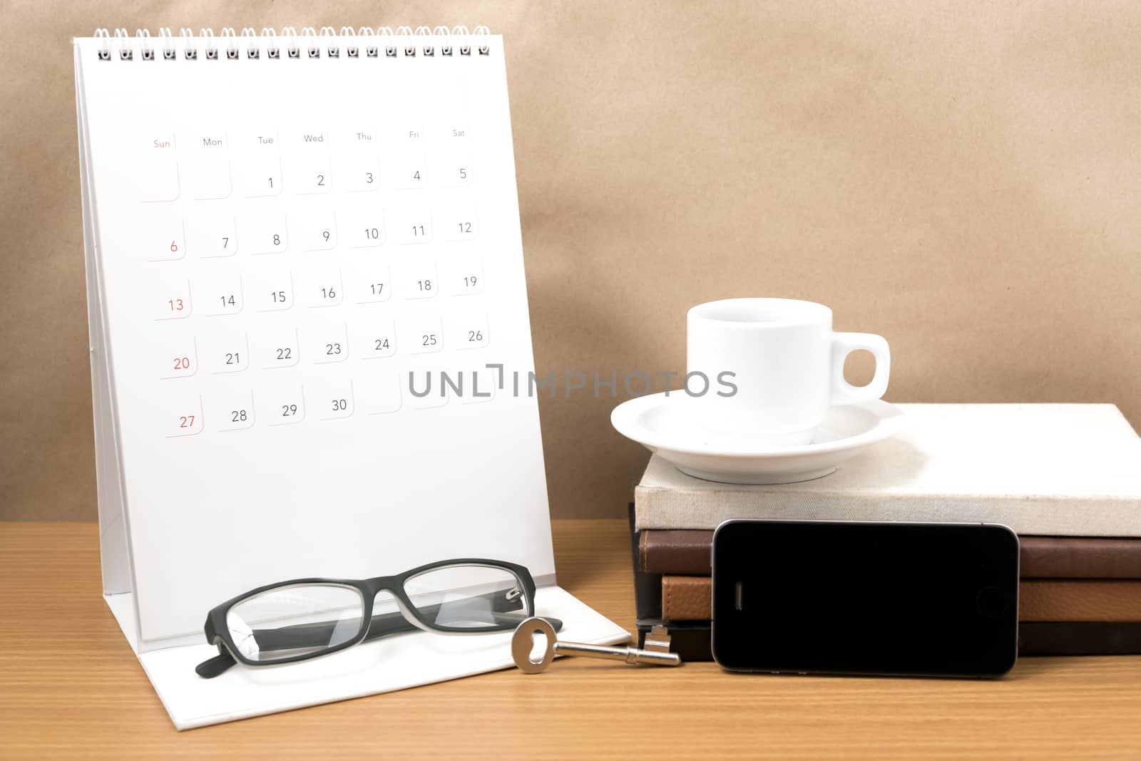 coffee and phone with key,eyeglasses,stack of book,calendar by ammza12