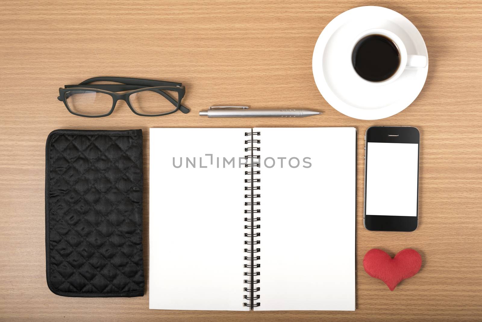 office desk : coffee with phone,notepad,eyeglasses,wallet,heart on wood background