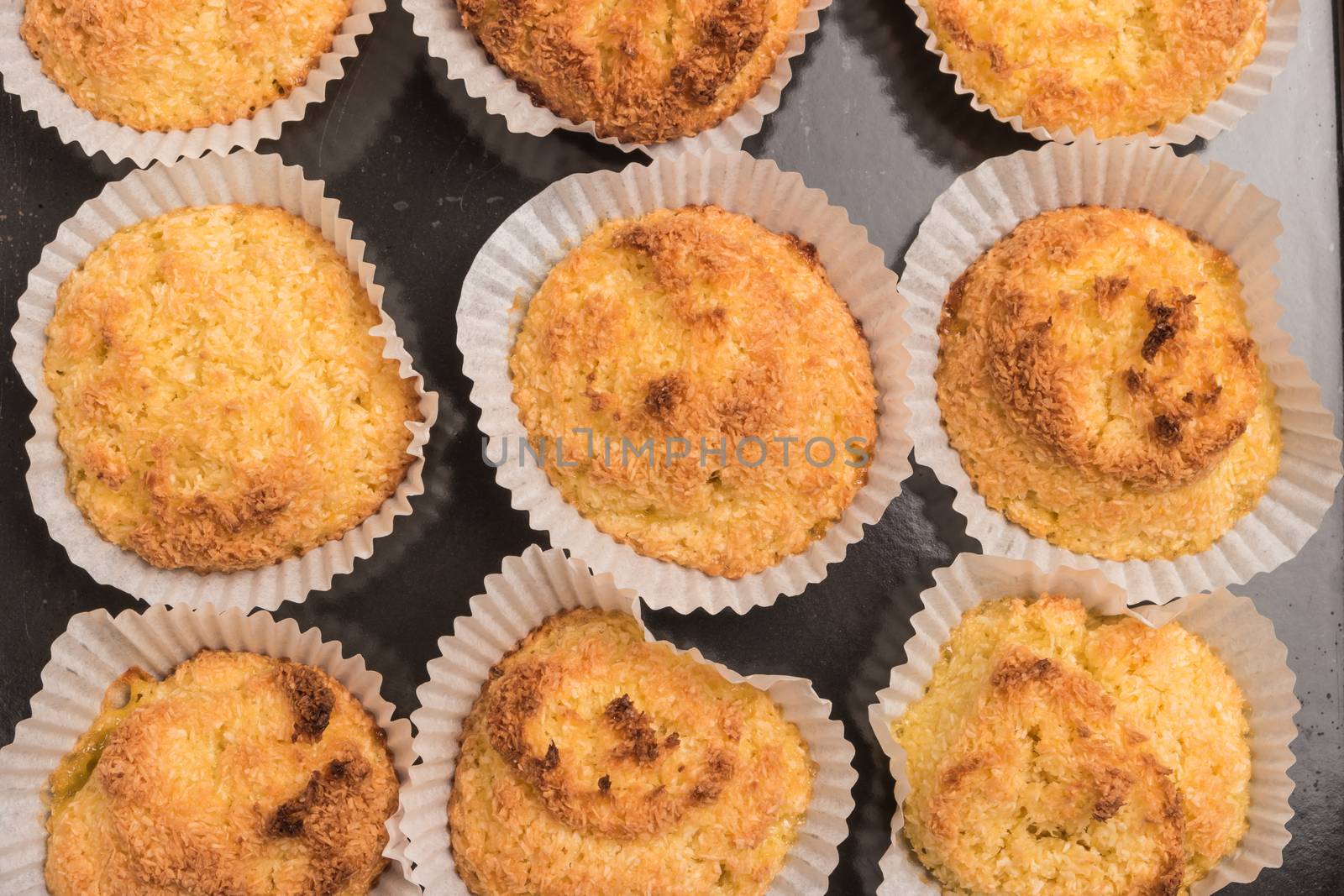 Close up of homemade coconut macaroons, cookie recipe in the oven. Top view with copy space.