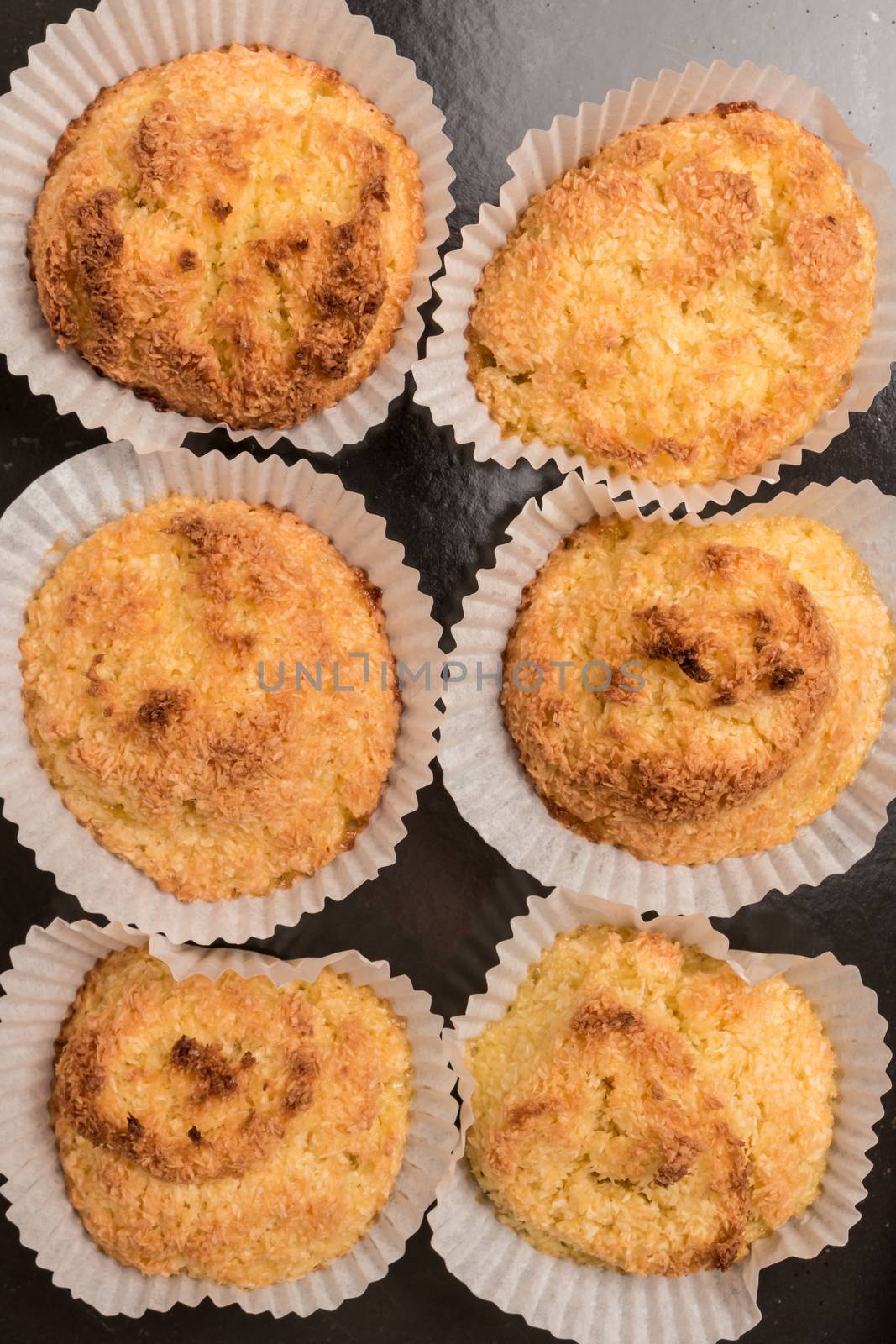 Close up of homemade coconut macaroons, cookie recipe in the oven. Top view with copy space.