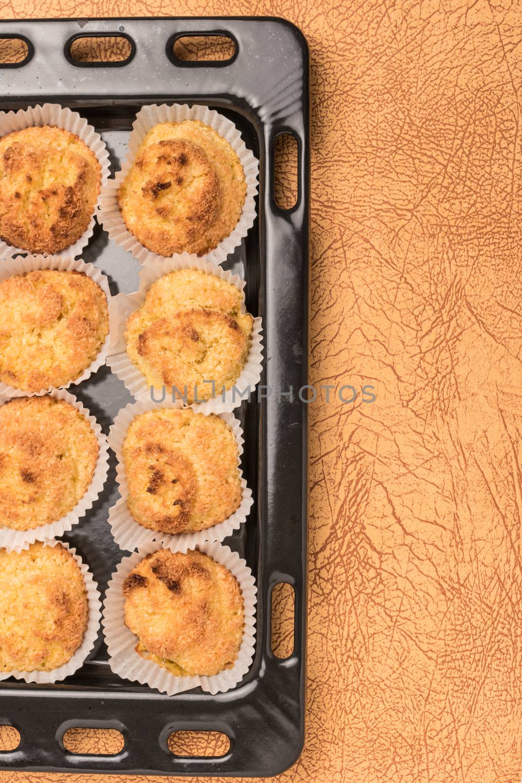 Close up of homemade coconut macaroons, cookie recipe in the oven. Top view with copy space.