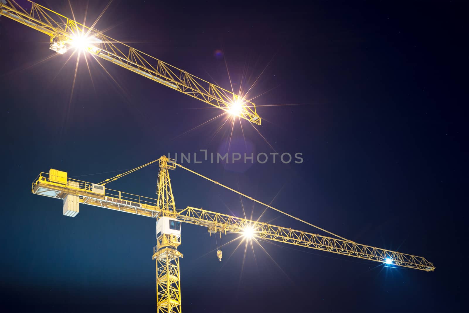 cranes and illumination at night, construction site