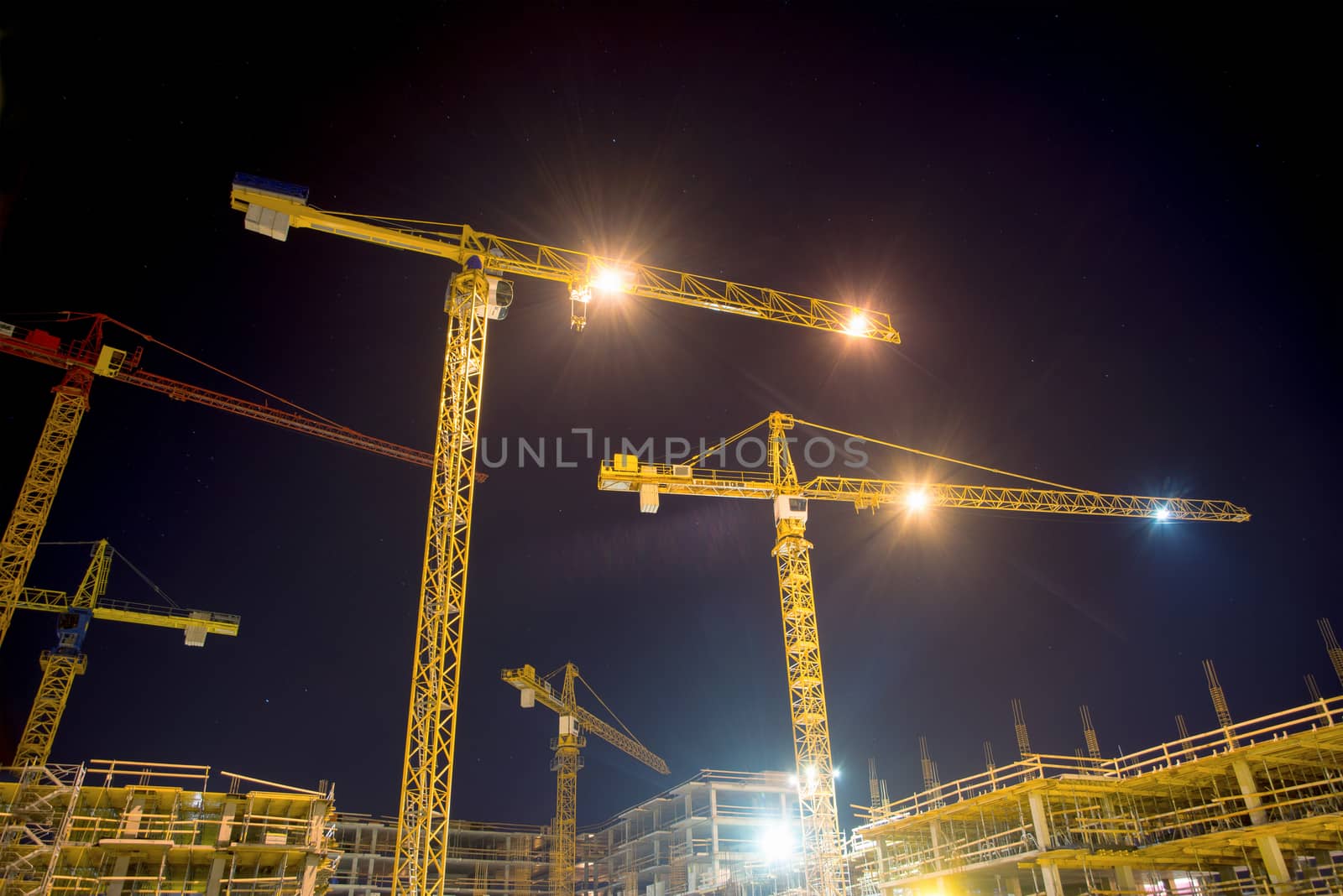 cranes and illumination at night, construction site