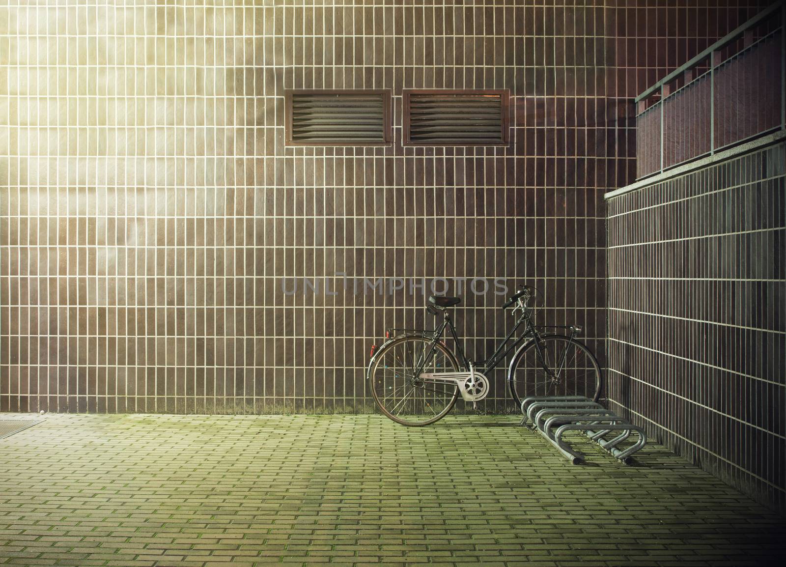 vintage bicycle near the concrete wall with ventilation hole