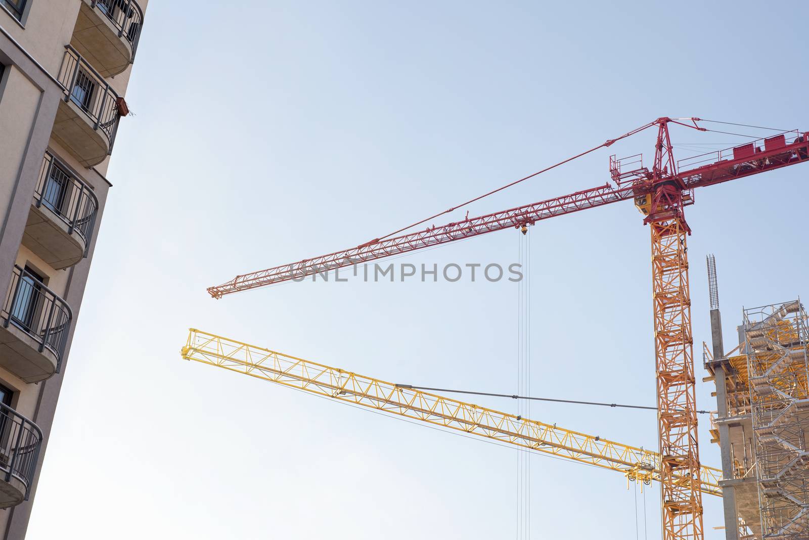 building and construction cranes, blue sky background 