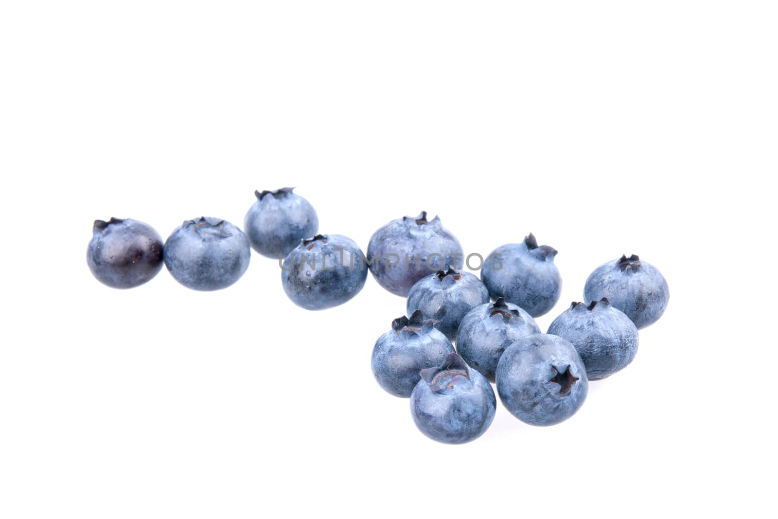 Fresh picked blueberries isolated on white background