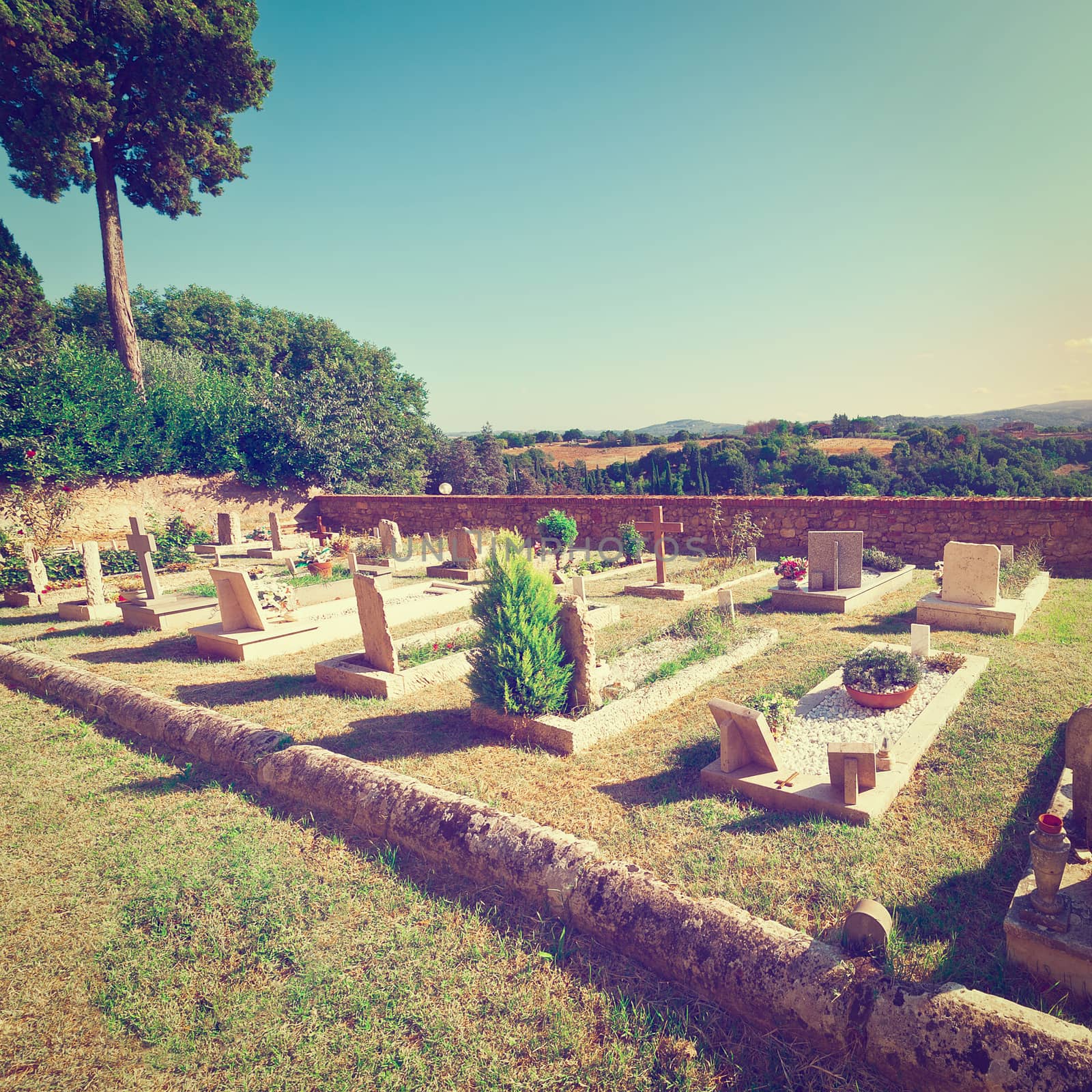 Churchyard on the Background of the Tuscan Landscape at Sunset, Vintage Style Toned Picture