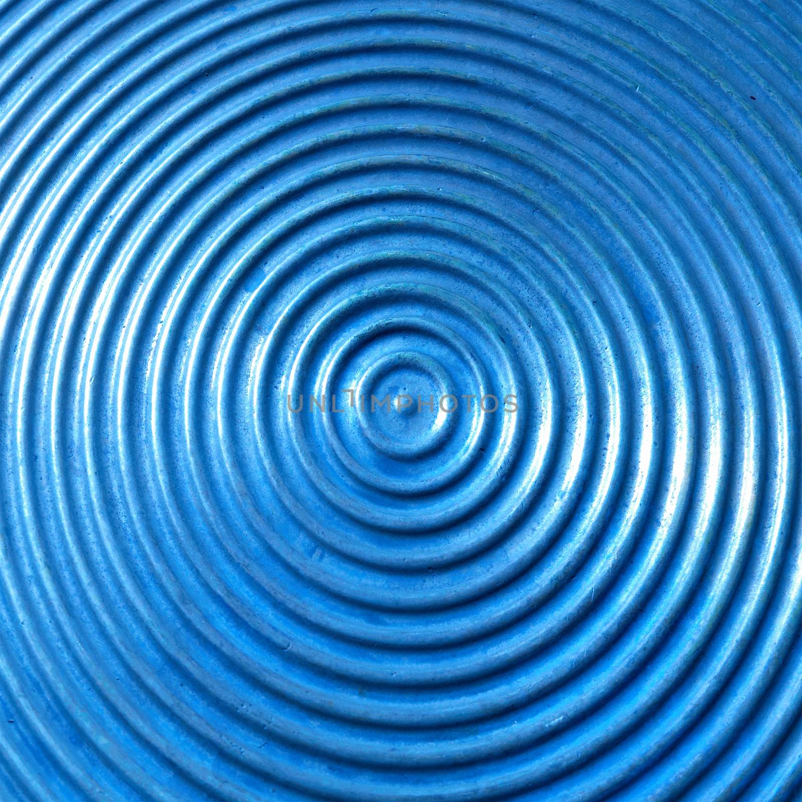 Abstract circle metal plate- blue surface with round lines.