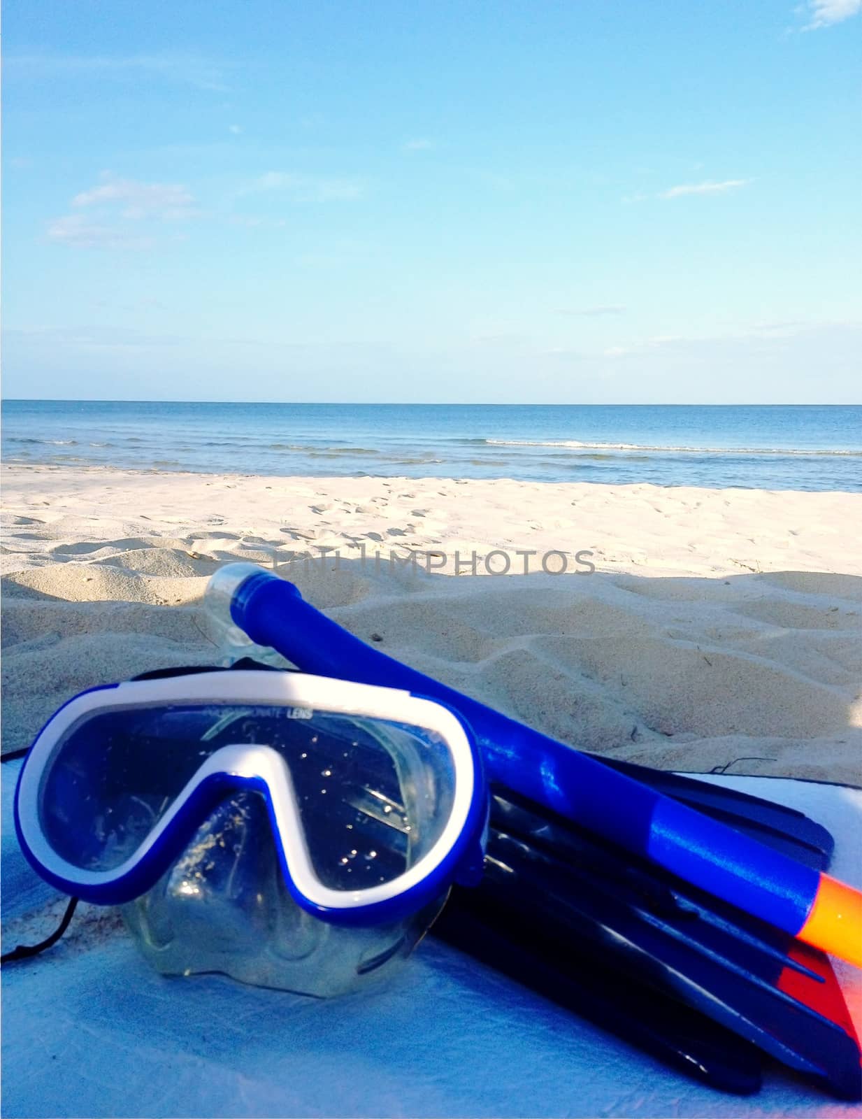 Diving goggles,snorkel on sand beach