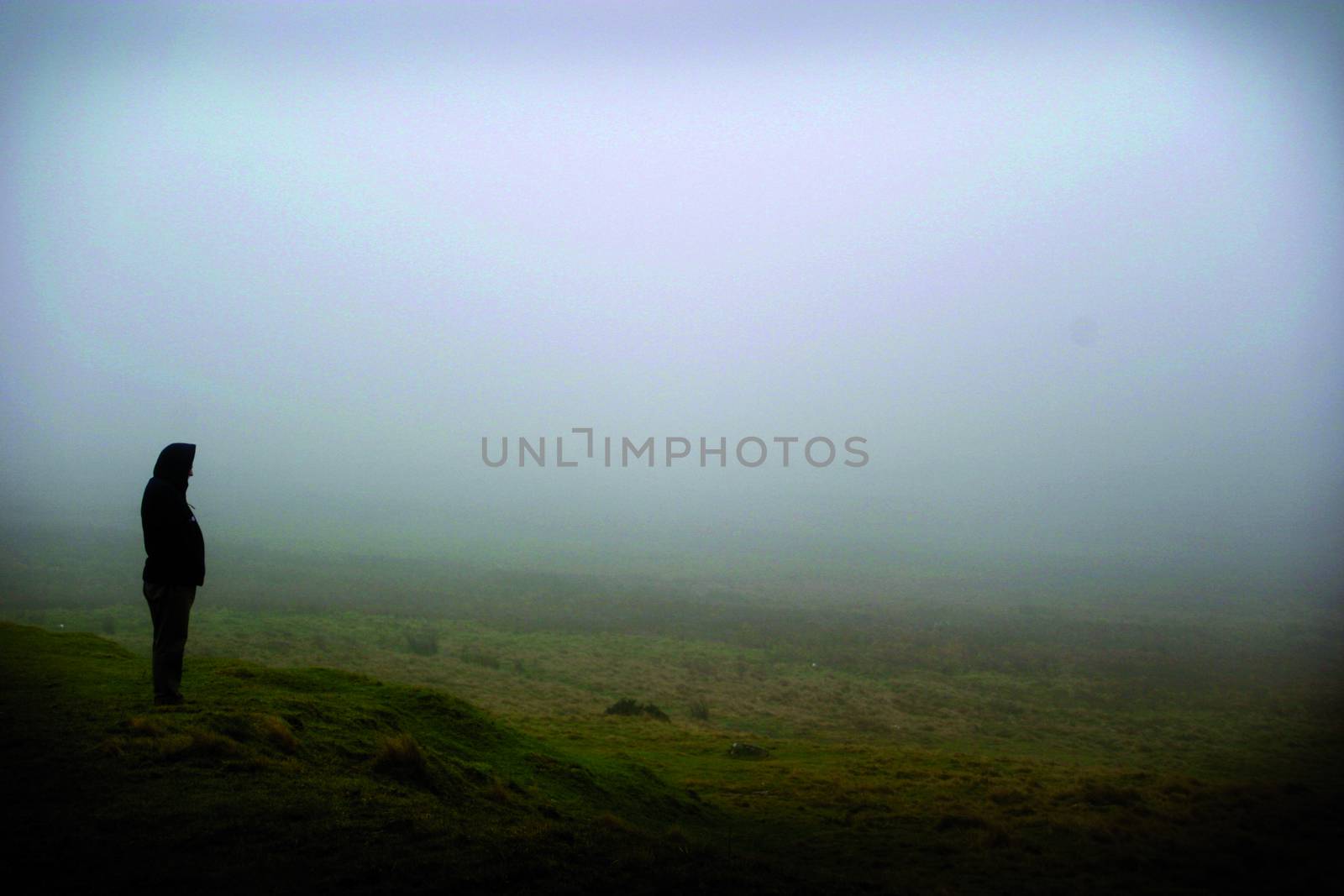 A lone man stood in the mist on the preseli mountains.