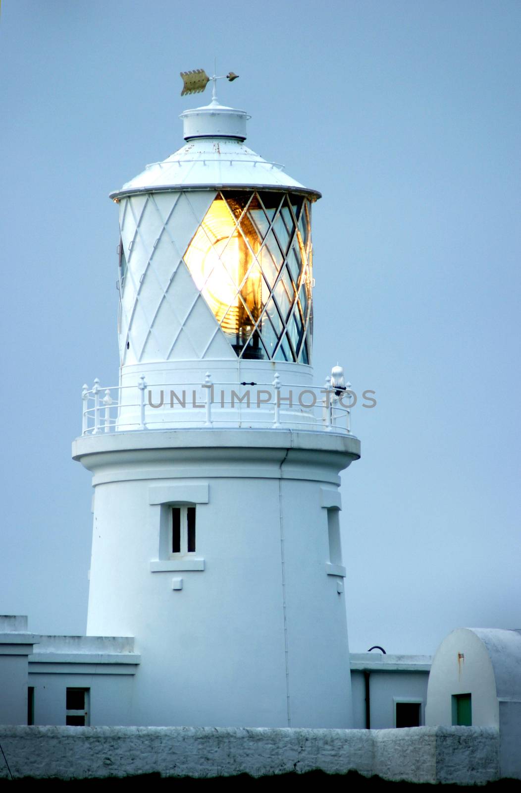 a large West Wales lighthouse with the light showing.