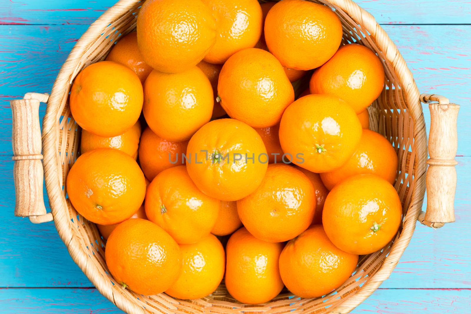 Fresh ripe juicy clementines in a wicker basket by coskun