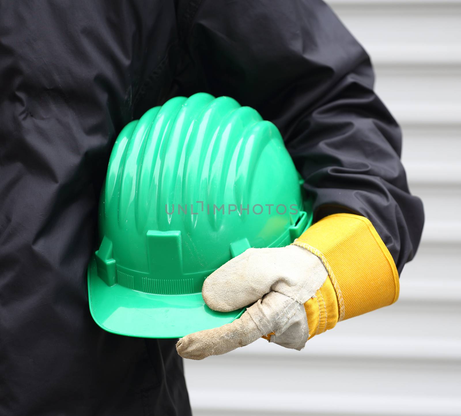 Man holding green helmet close up