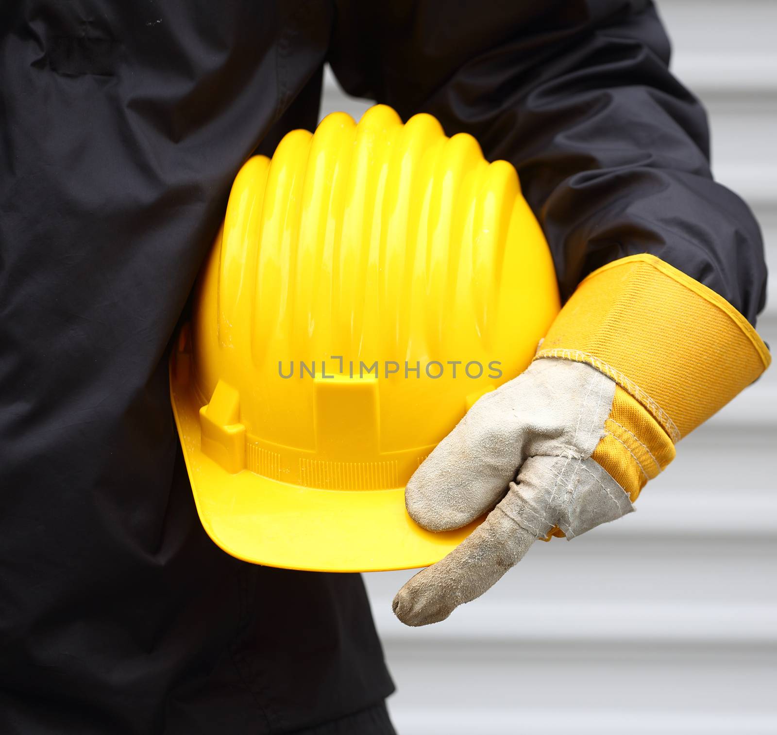 Man holding yellow helmet close up