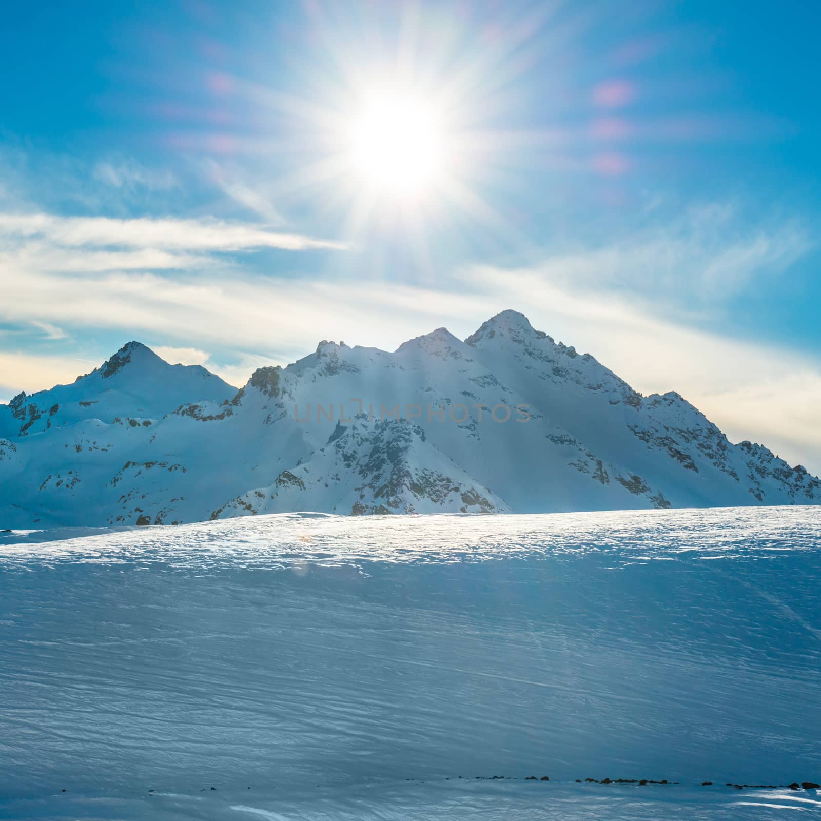 Snowy blue mountains in clouds by vapi