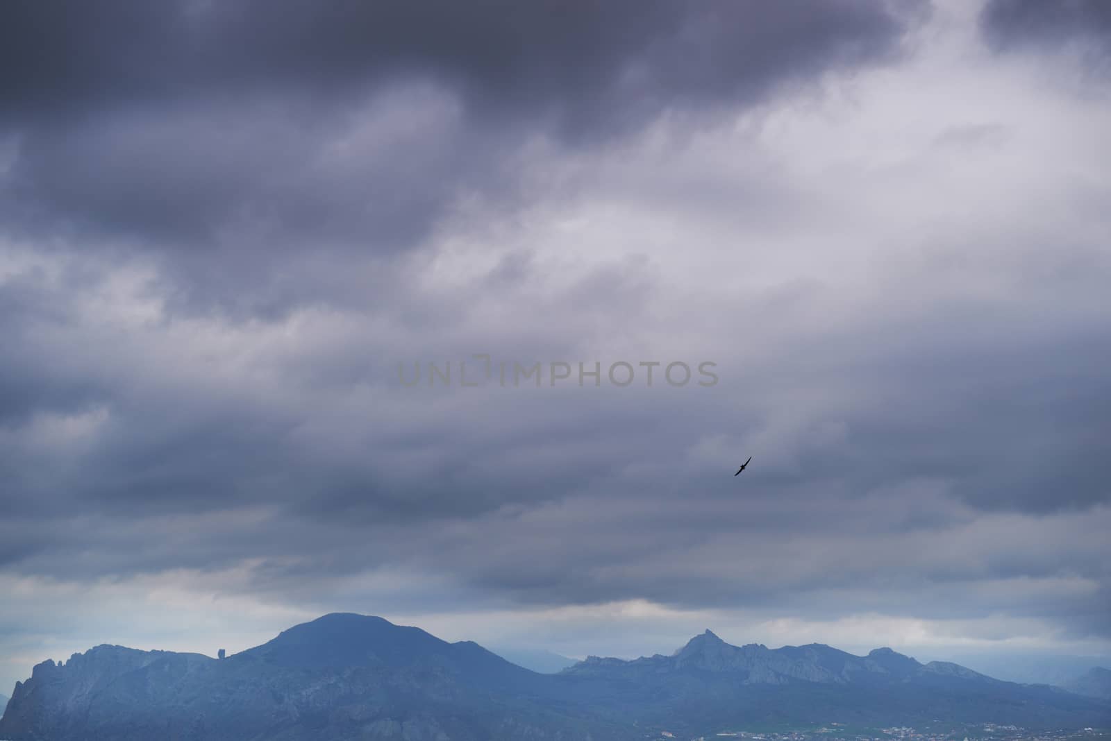 Dramatic sea with island and blue dark sky