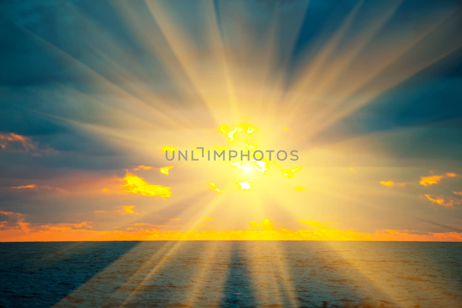 Sunset above sea, with waves, dramatic clouds on the sky