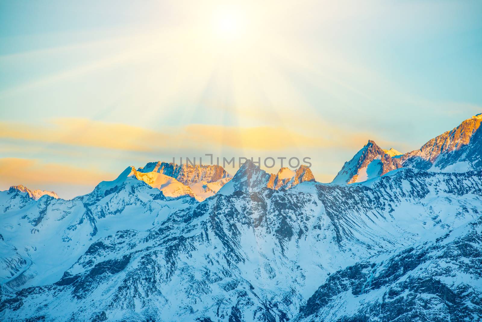 Sunset in mountains covered by snow.