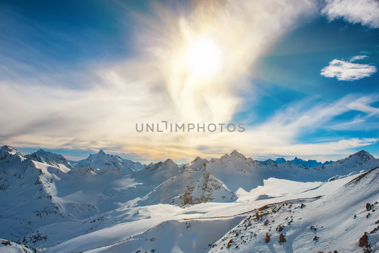 Snowy blue mountains in clouds. Winter ski resort