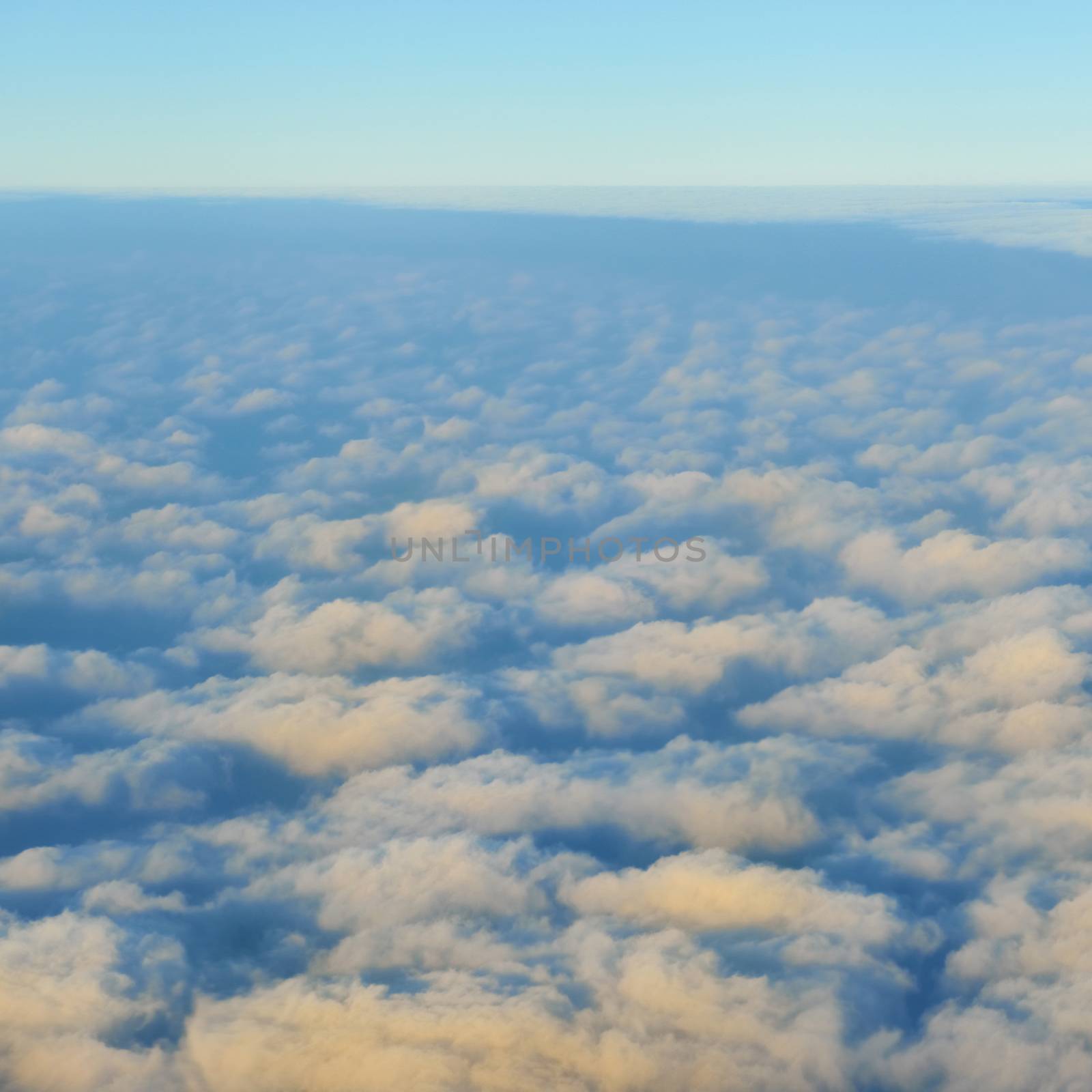 Amazing view from plane on the sky, sunset sun and clouds