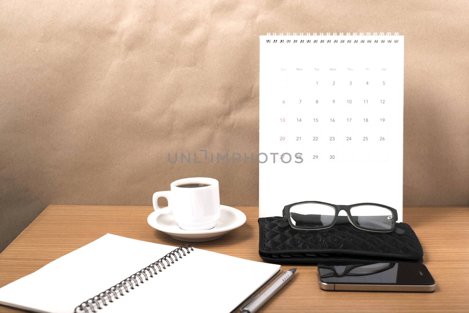 office desk : coffee with phone,calendar,wallet,notepad on wood background