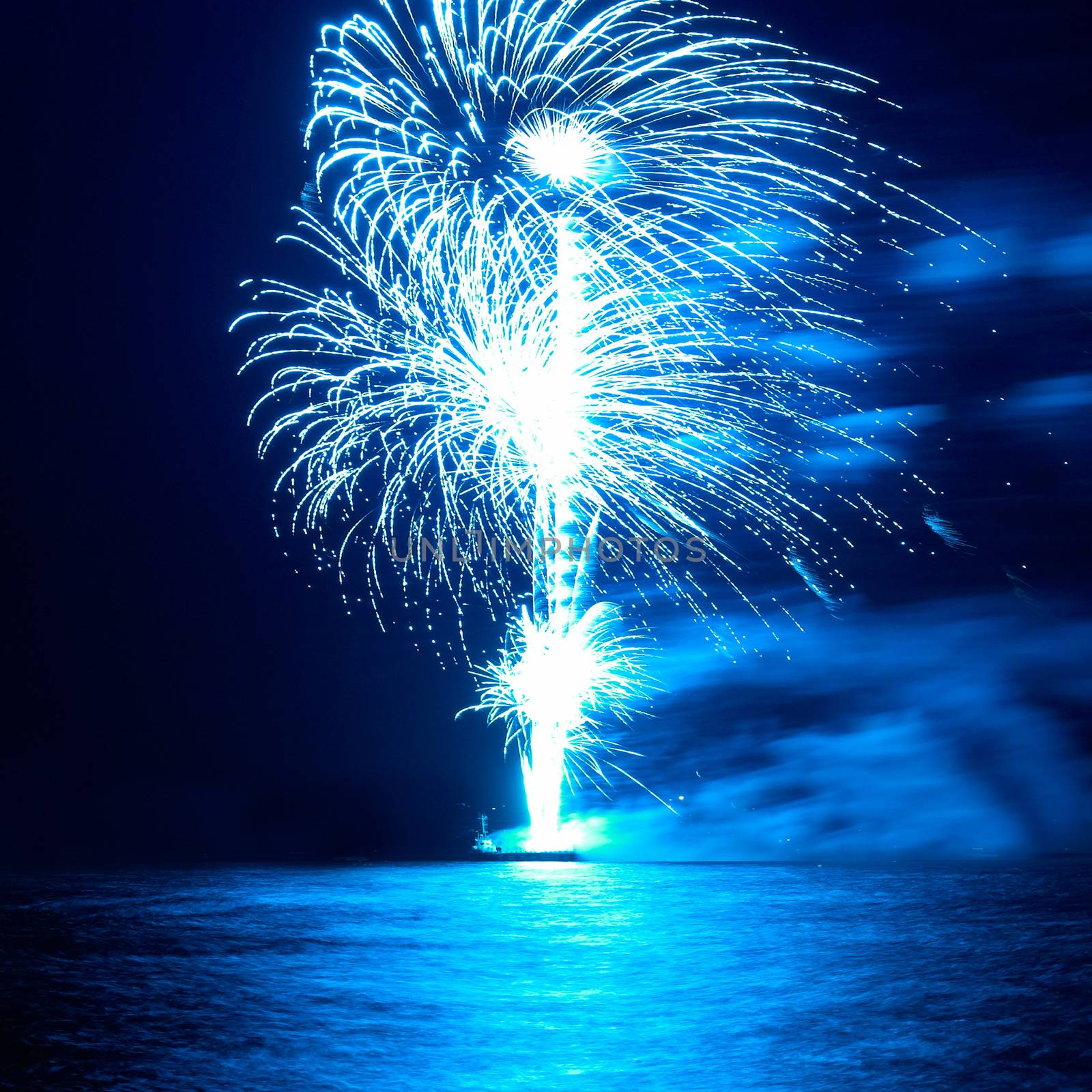 Blue colorful holiday fireworks on the black sky background.