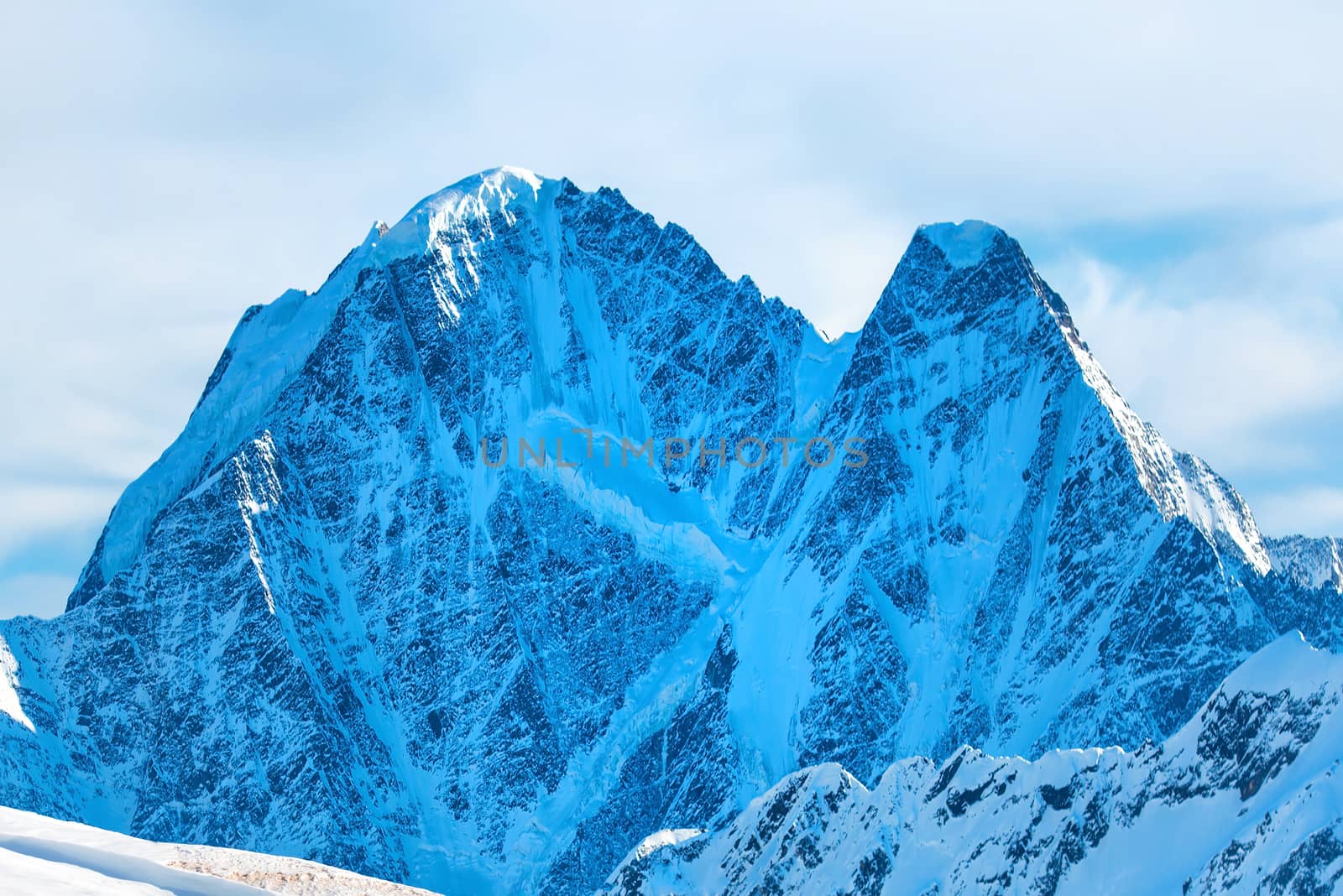 Snowy blue mountains in clouds. Winter ski resort