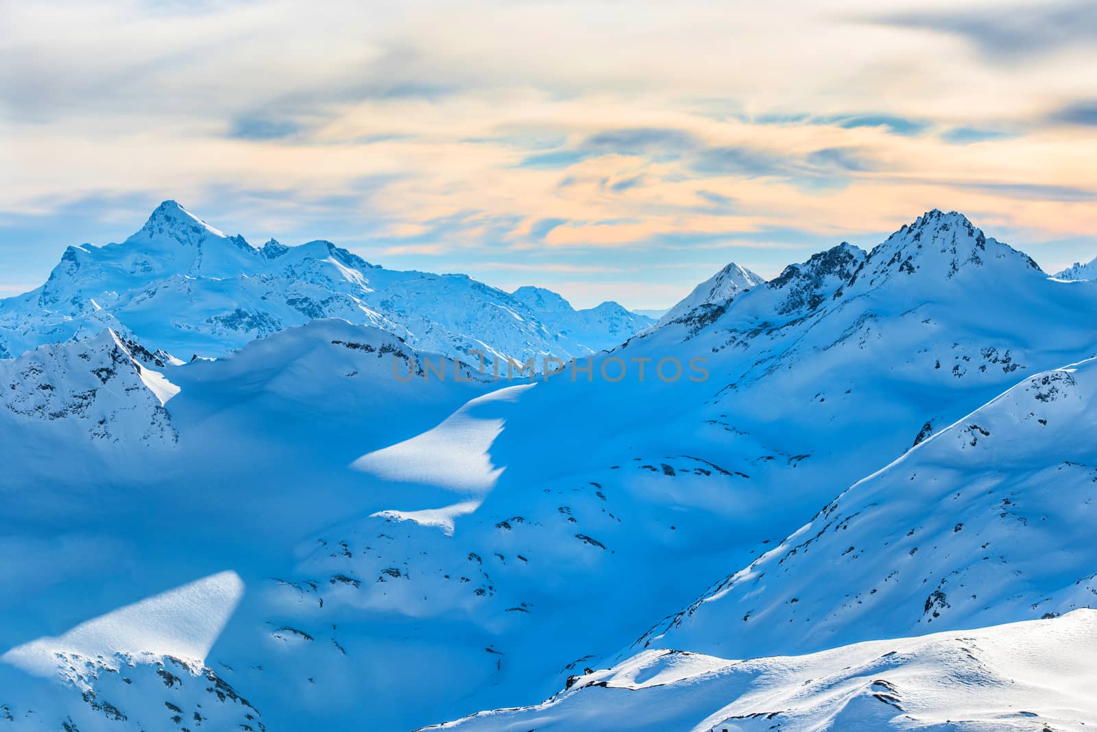 Snowy blue mountains in clouds by vapi