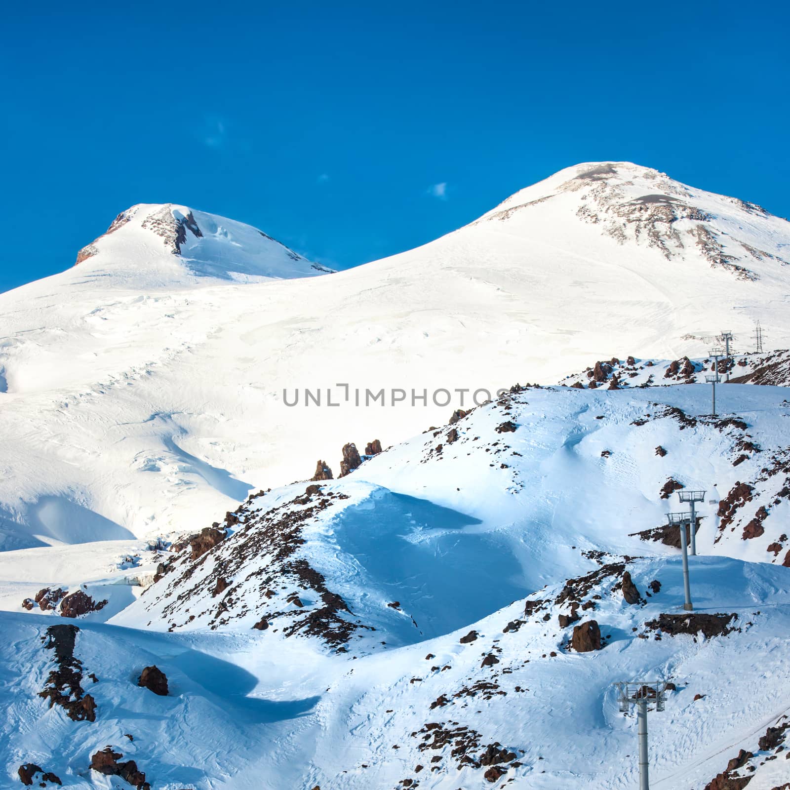 Two peaks of Elbrus mountain in snow. Winter landscape.