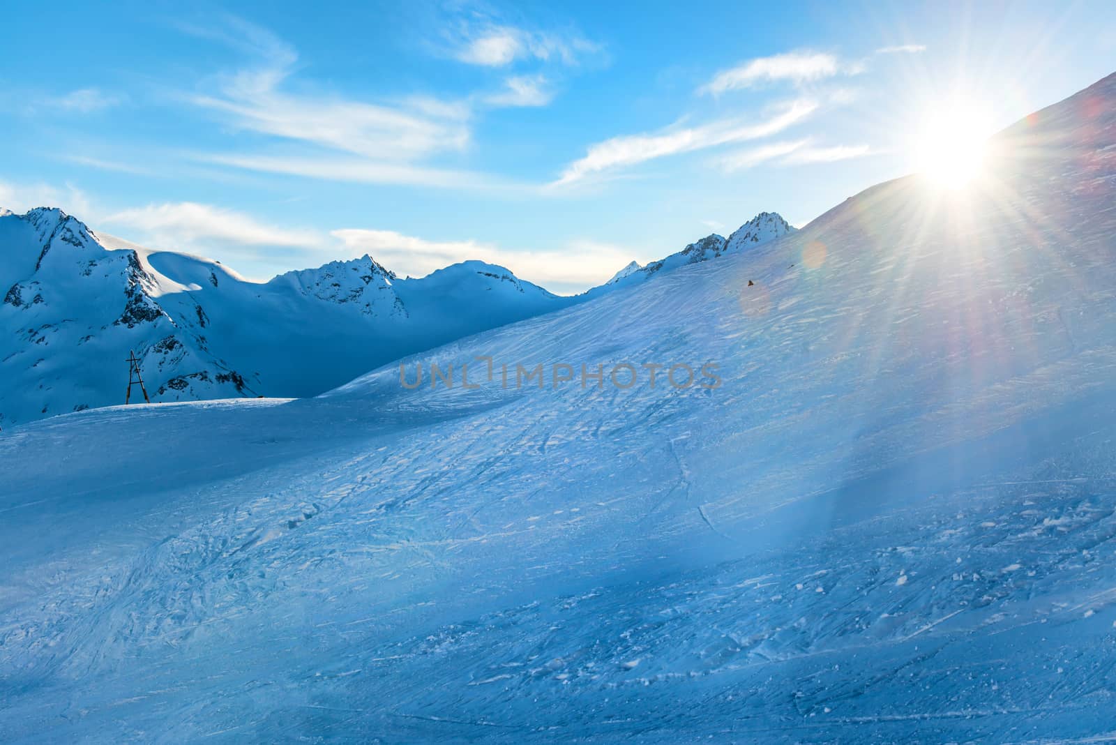 Snowy blue mountains in clouds by vapi