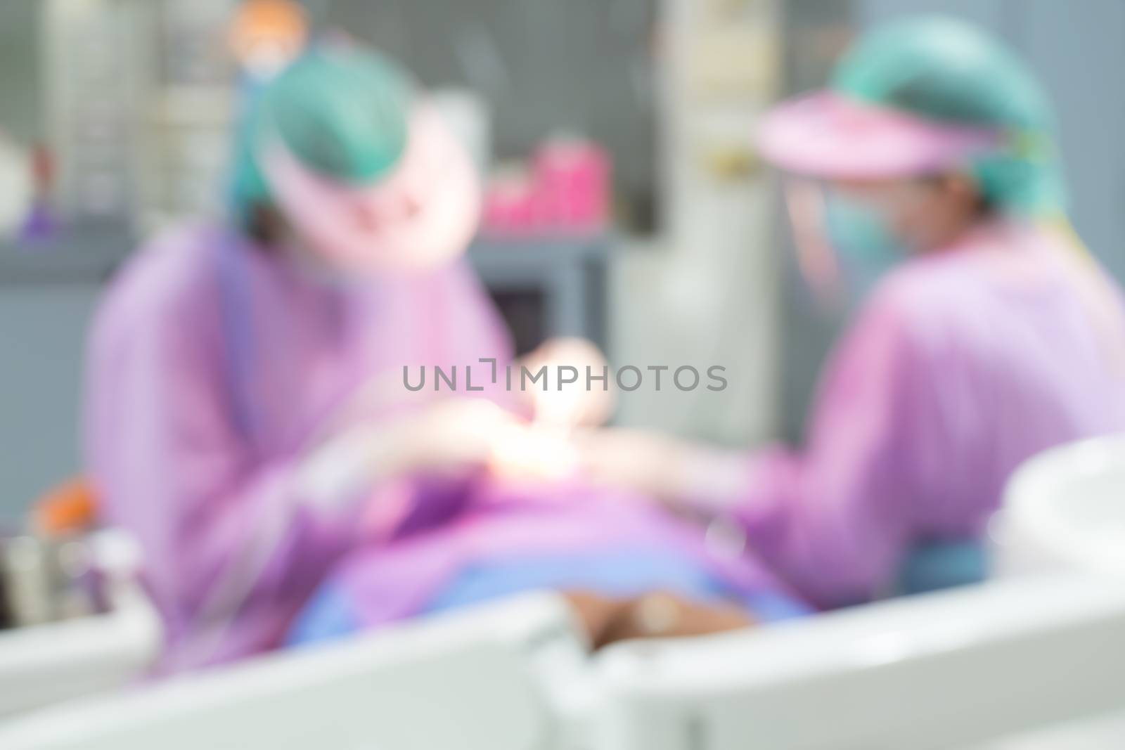 Dentist and Dental assistants in hospital ( blurry dental background ) by stockdevil