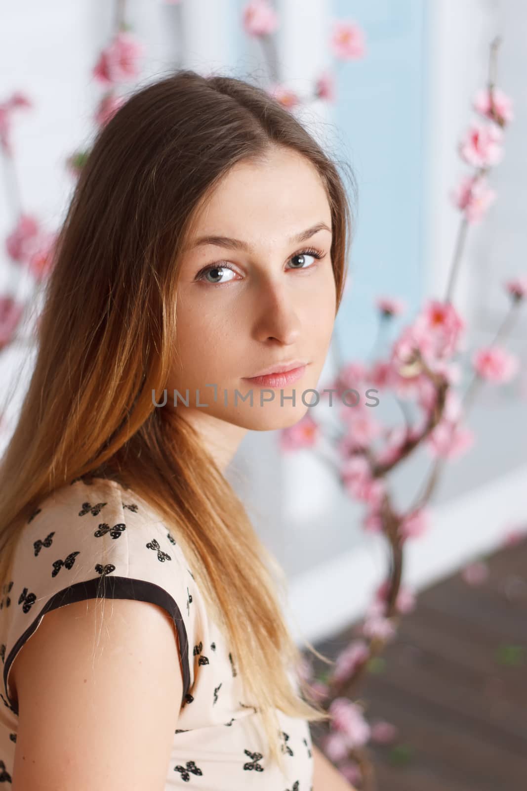 Beautiful girl with long hair in a flowering garden