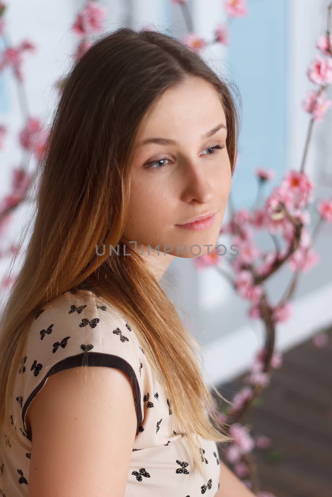 Beautiful girl with long hair in flowering garden by victosha