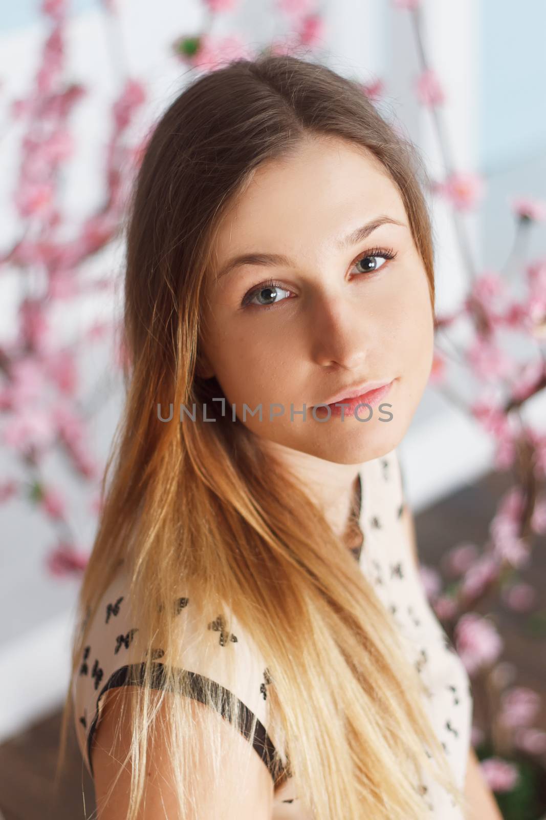 Beautiful girl with long hair in a flowering garden