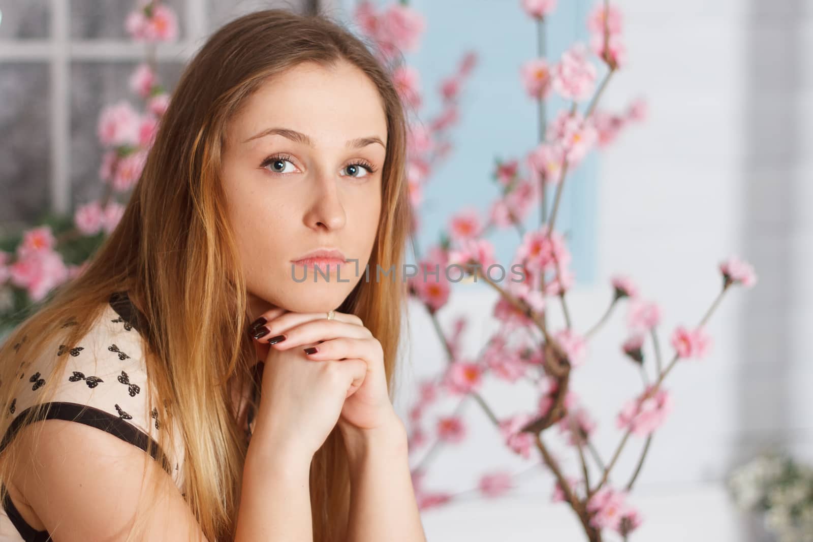 Beautiful girl with long hair in a flowering garden