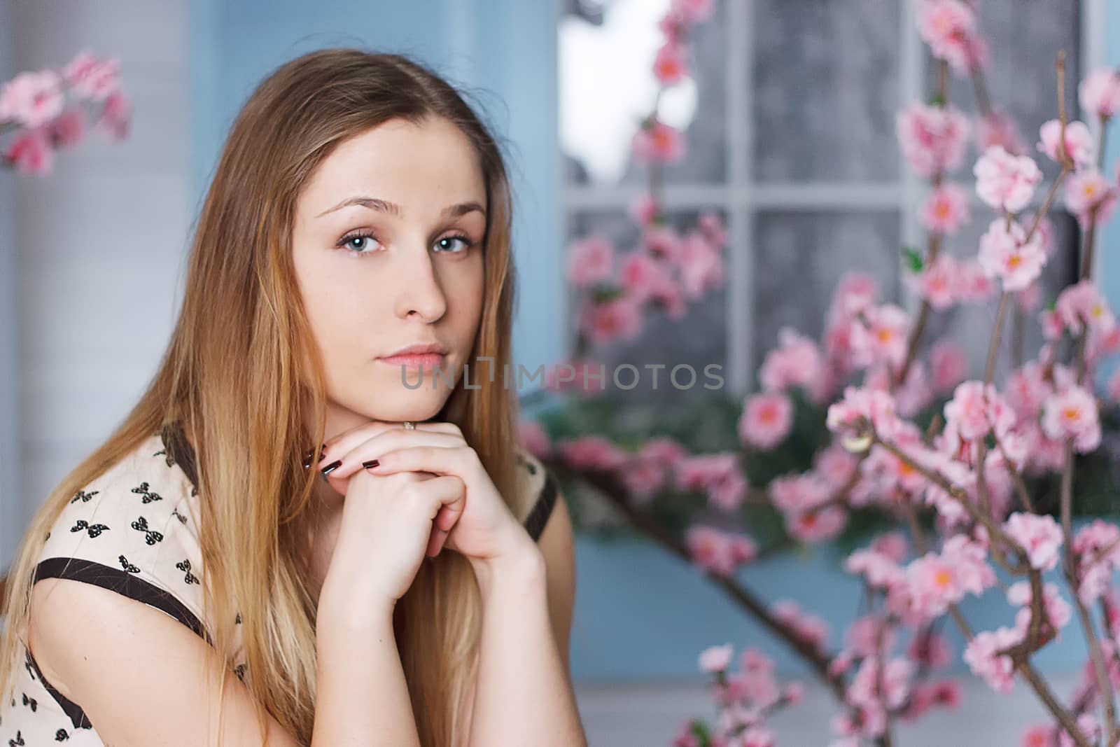 Beautiful girl with long hair in a flowering garden