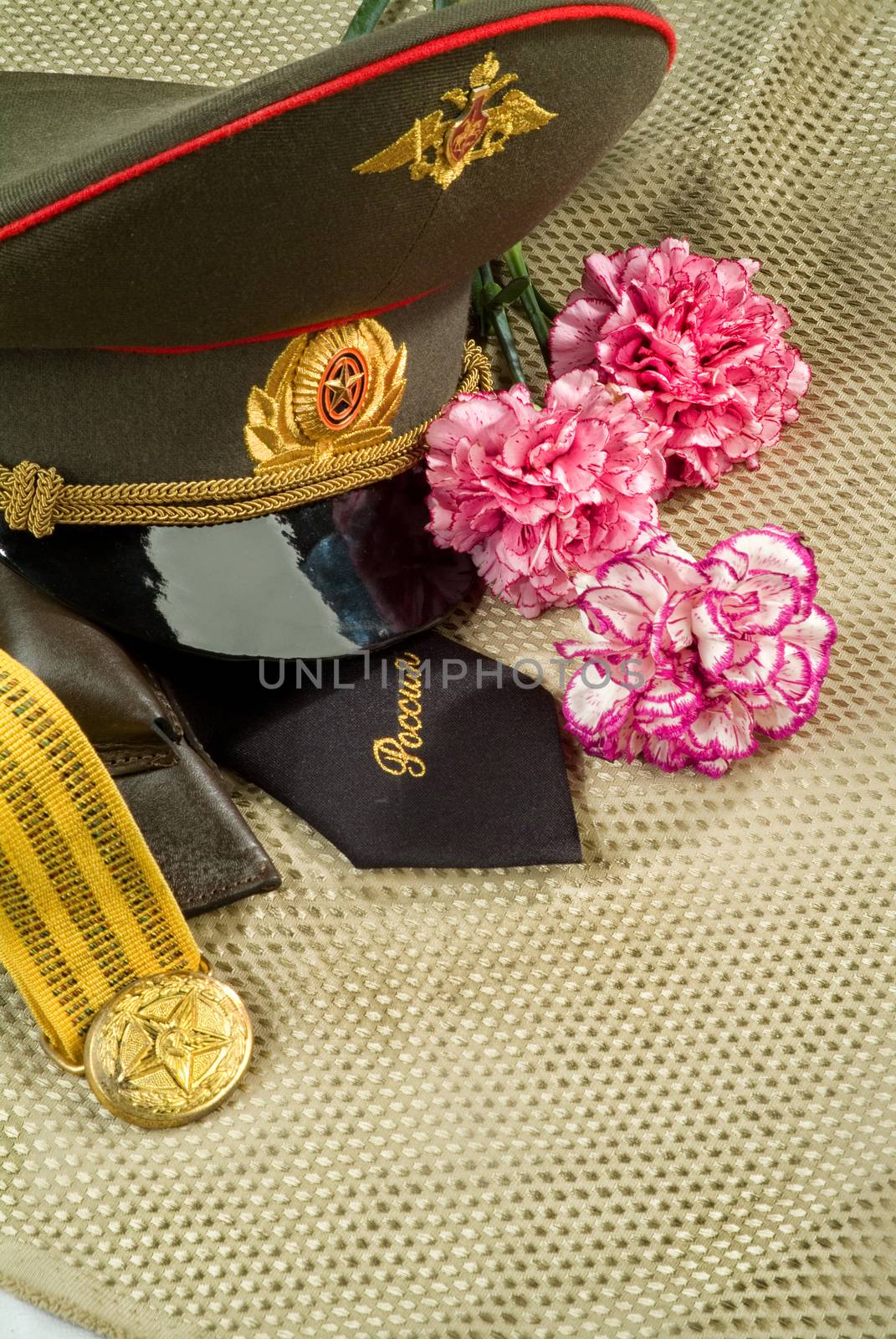 Flowers and army equipment on a studio background