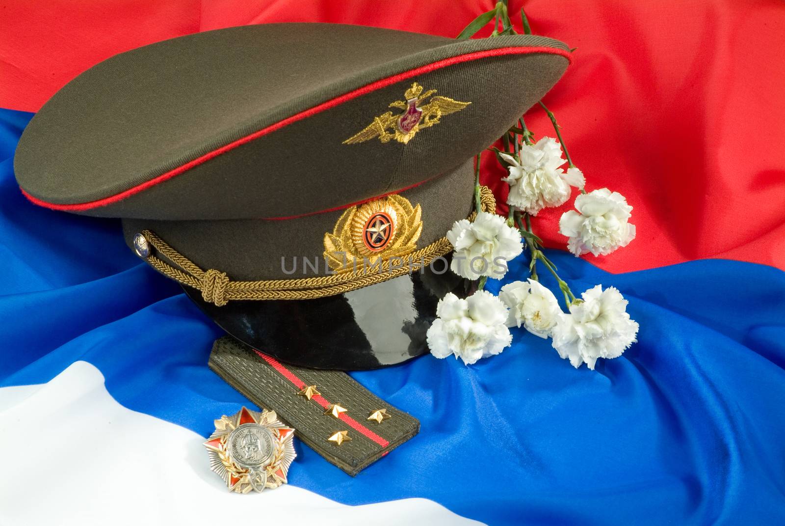 Flowers and army equipment on a studio background