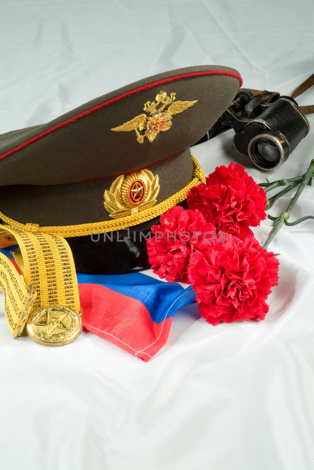 Flowers and army equipment on a studio background