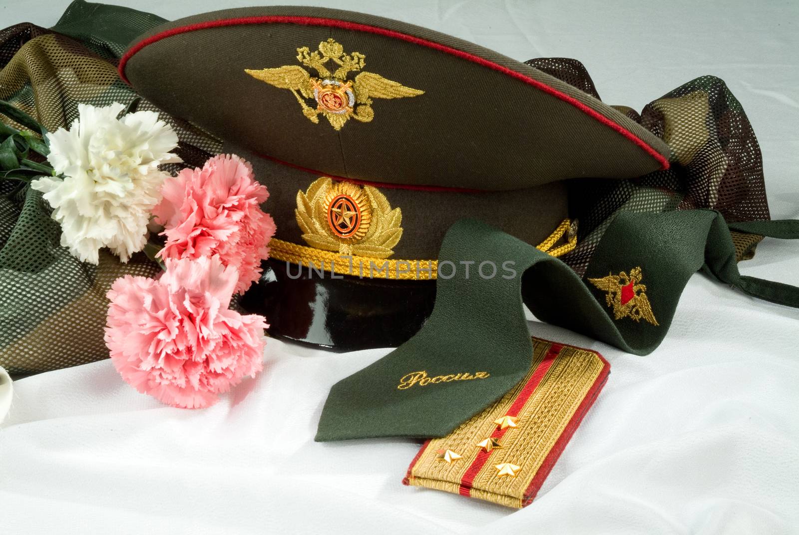 Flowers and army equipment on a studio background