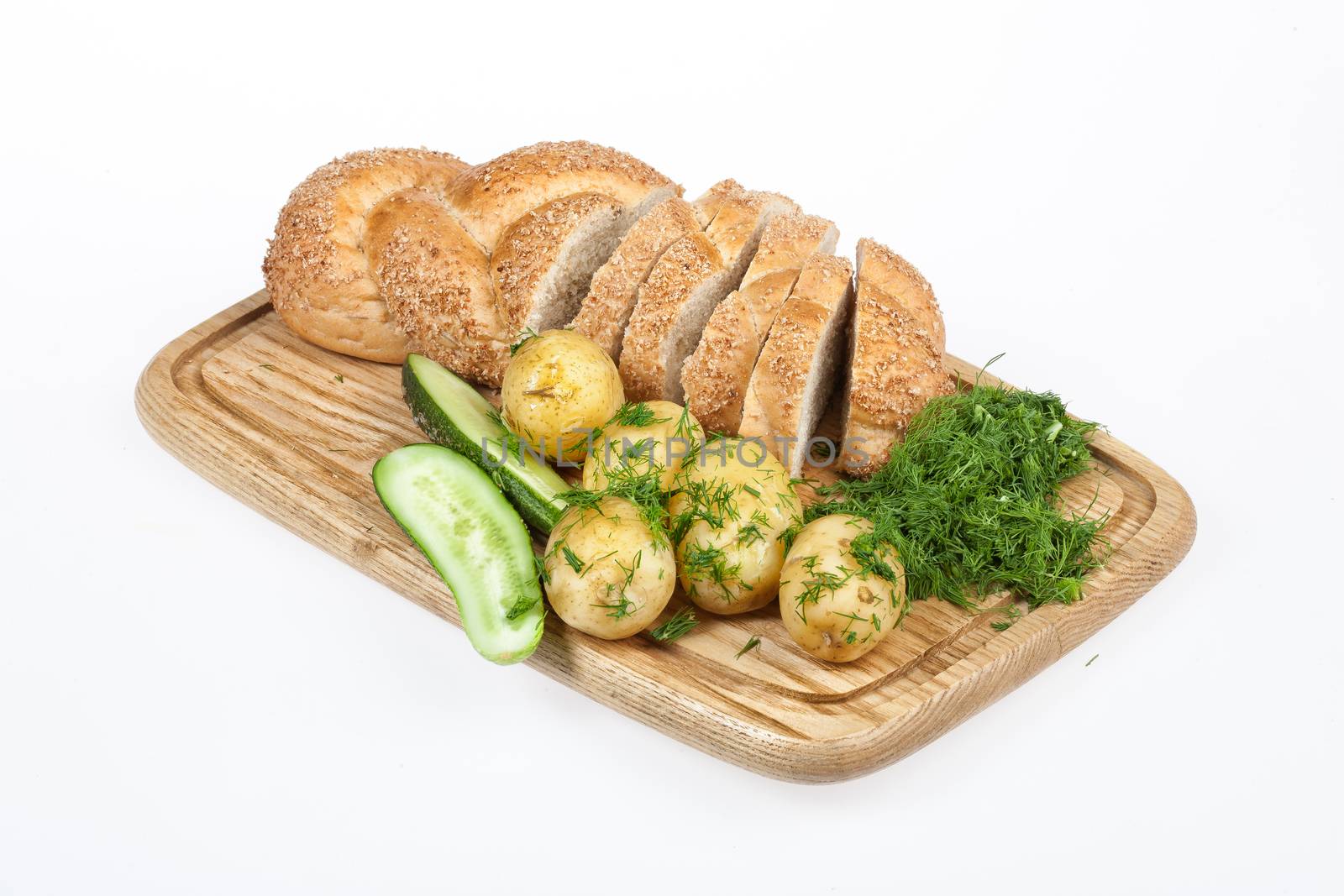 Potatoes, greenery and tableware on isolated satudio background