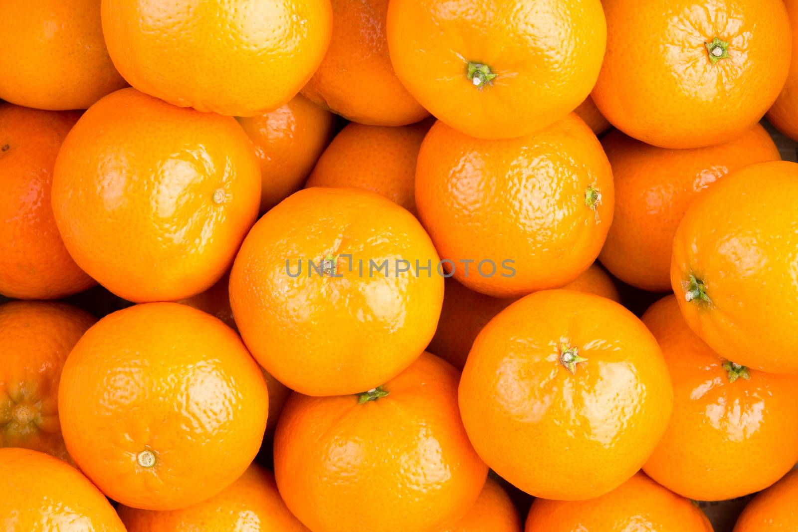 Food background of fresh healthy ripe orange clementines, tangerines or mandarins in a full frame view rich in vitamin c