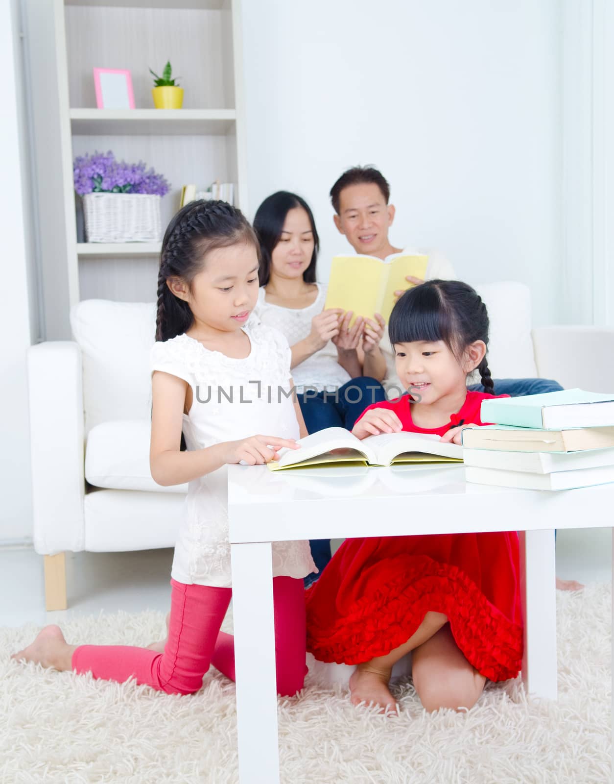 Family reading book at home