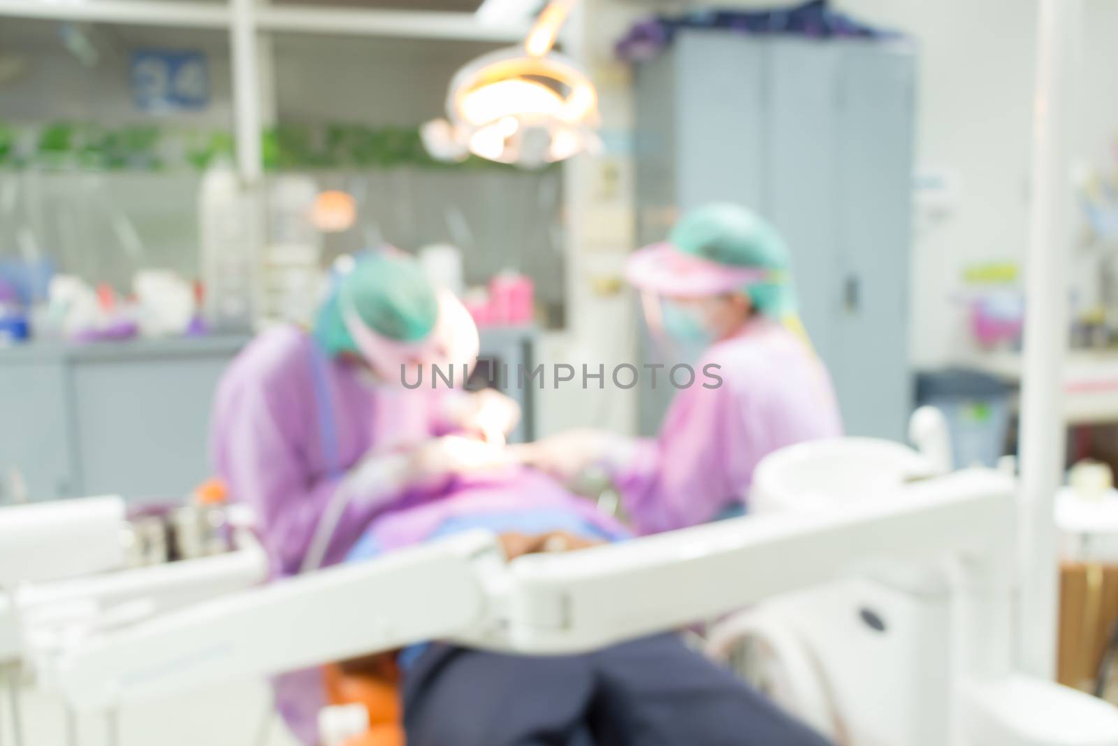 Dentist and Dental assistants in hospital ( blurry dental background ) in thailand by stockdevil