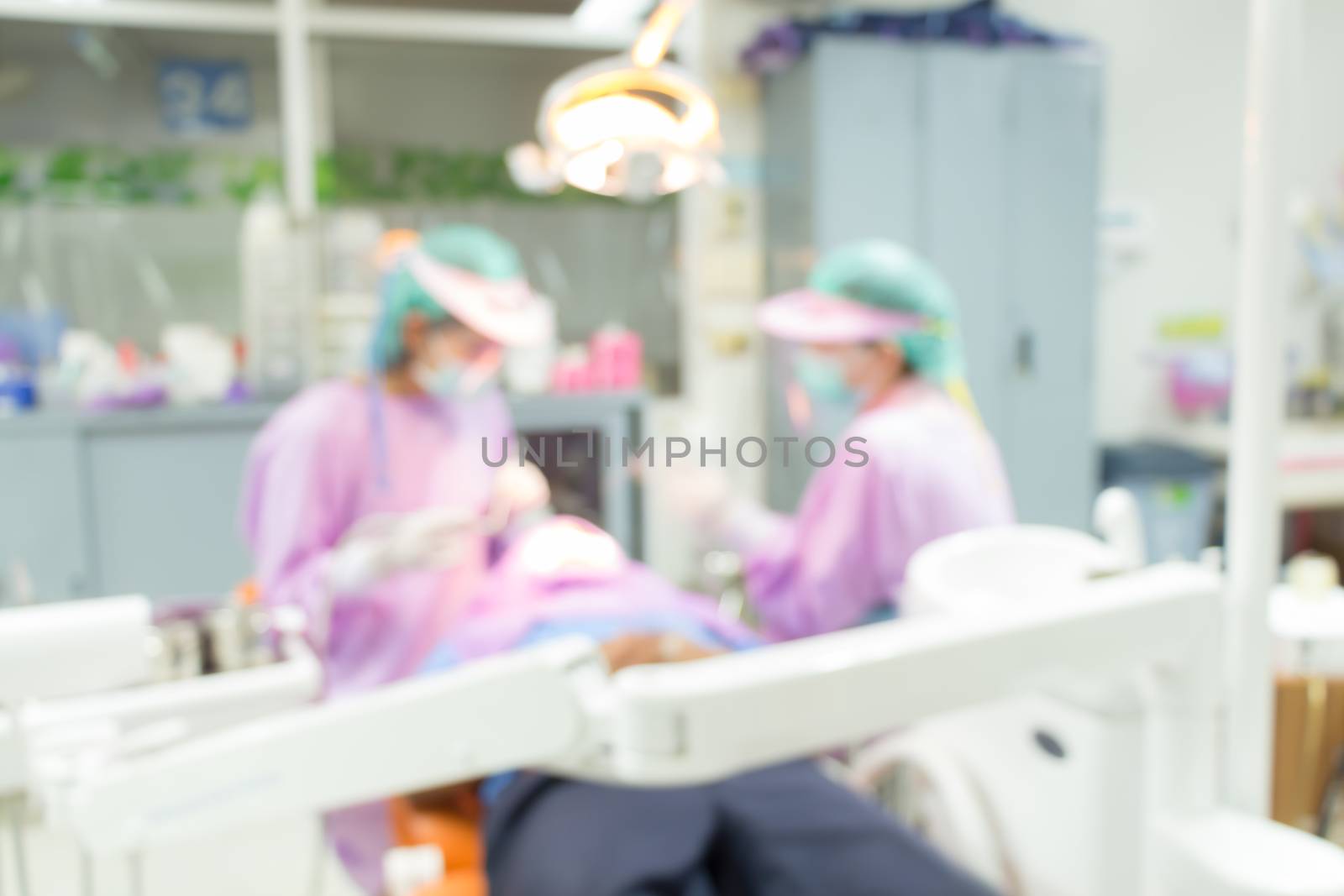 Dentist and Dental assistants in hospital ( blurry dental background ) in thailand by stockdevil