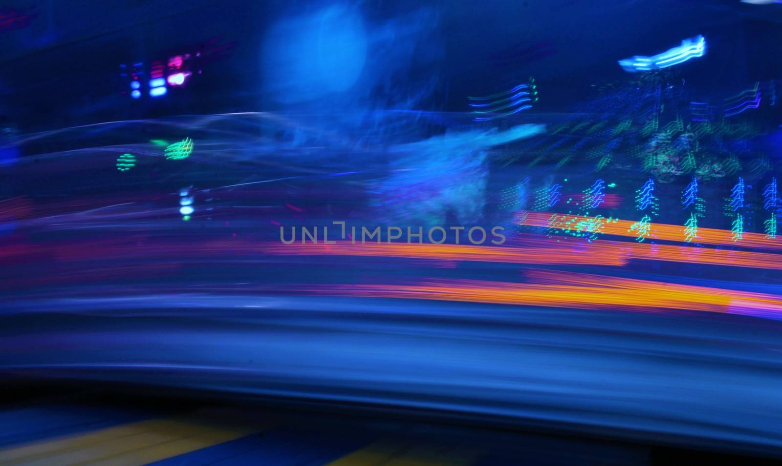 Night colors of the amusement park lights moving, light trails, slow shutter-speed