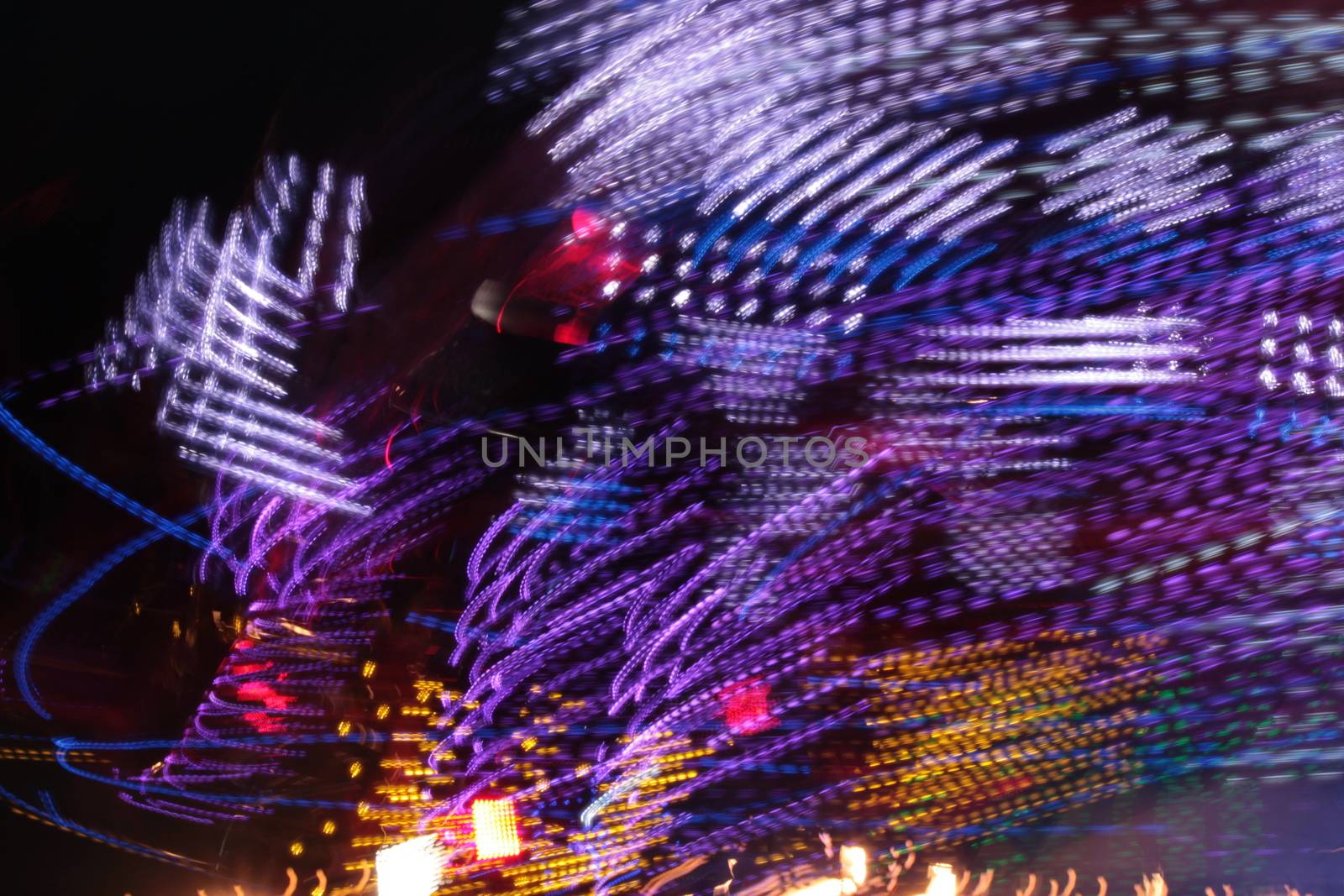 Night colors of the amusement park lights moving, light trails, slow shutter-speed