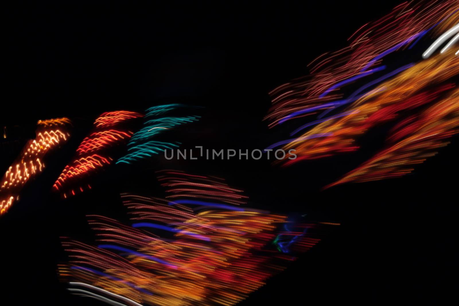 Night colors of the amusement park lights moving, light trails, slow shutter-speed